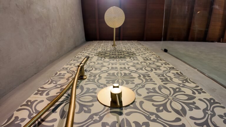 Bathroom shelf detail at The Mahaloka showing neatly rolled towels, spare toilet paper, and a hairdryer.