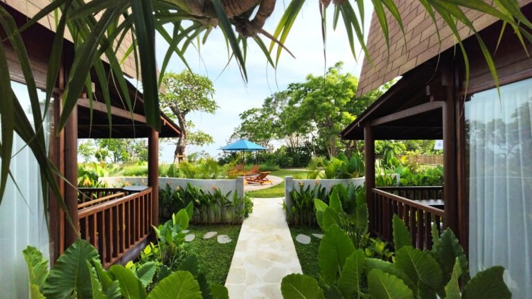 Ground level symmetrical view up the stone garden path between the two lumbung villas at The Mahaloka.