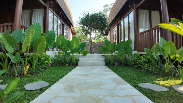 Ground level symmetrical view up the stone garden path between the two lumbung villas at The Mahaloka.