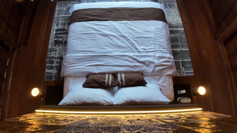 Alternative overhead view looking down onto the king bed in The Mahaloka loft, showing textures of rug and bedding.