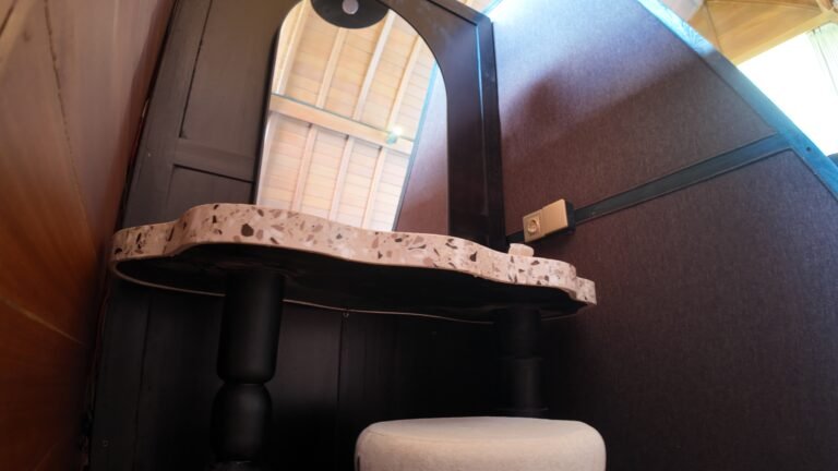 Detail shot of the makeup vanity desk and stool tucked into the angled wall of The Mahaloka's king loft bedroom.