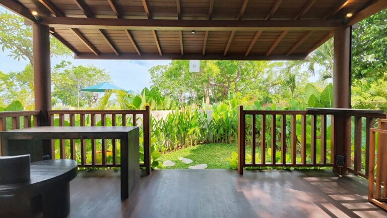 View from the spacious covered wooden deck of The Mahaloka lumbung, looking out towards the garden path and sanctuary grounds.