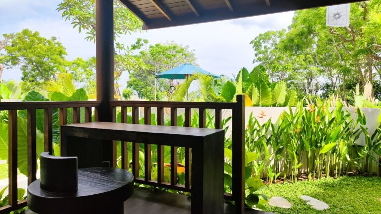 View from the covered wooden deck workstation at The Mahaloka lumbung, overlooking the lush tropical garden.